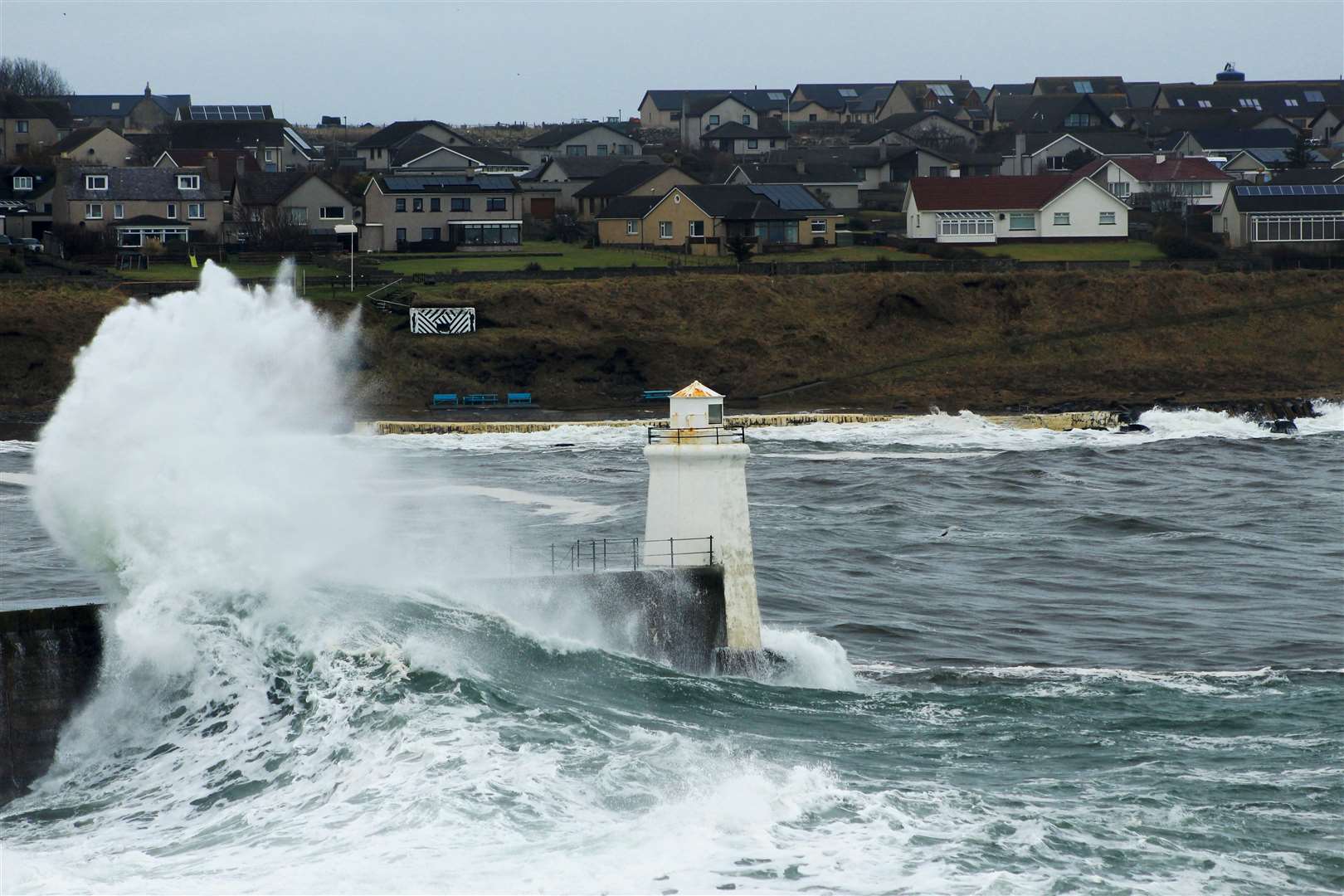 Another wave hits the outer harbour wall at Wick. Picture: Alan Hendry