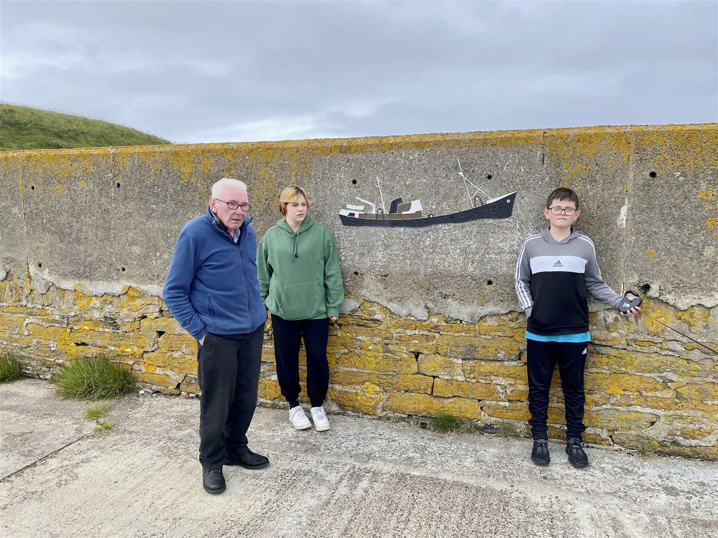 Derry Ross at the pier with grandchildren Kai (15) and Michael Ross (13). Picture: Willie Ross