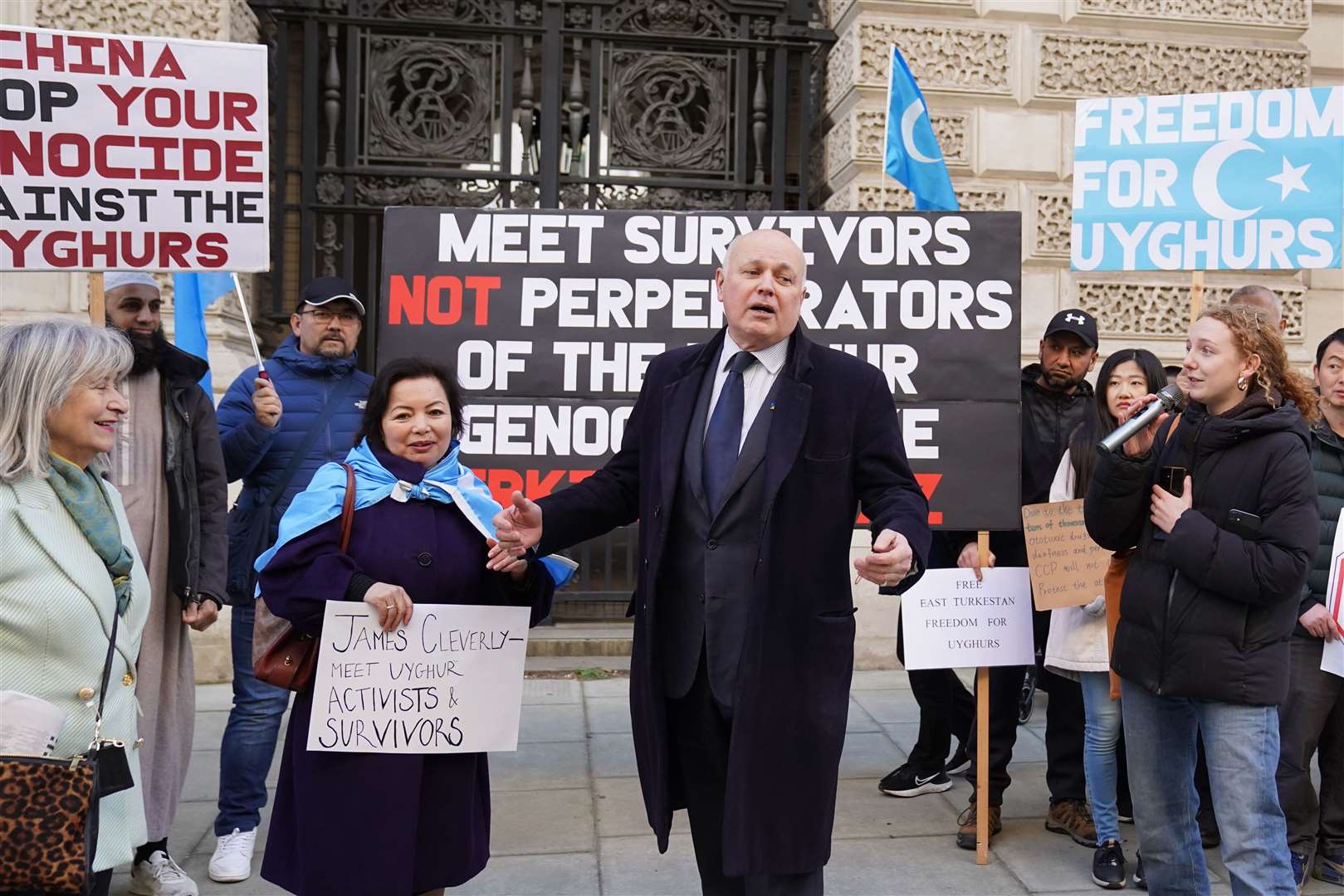 Sir Iain Duncan Smith, centre, and Labour peer Helena Kennedy, left, co-chairs of the Inter-Parliamentary Alliance on China, joined artist Rahima Mahmut at a vigil outside the Foreign Office in London to protest against a planned visit to the UK of Erkin Tuniyaz (Stefan Rousseau/PA)