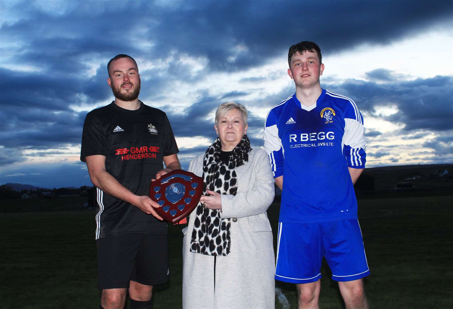 Susan Banks presenting the Craig Banks Memorial Shield to Lybster captain Gary Swanson (left), with Kyle Sutherland of Keiss looking on. Picture: Alan Hendry