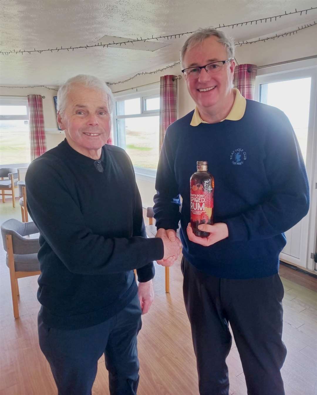 David A Craig (right) receiving a bottle of North Point Distillery spirits from senior section convener Sandy Chisholm.