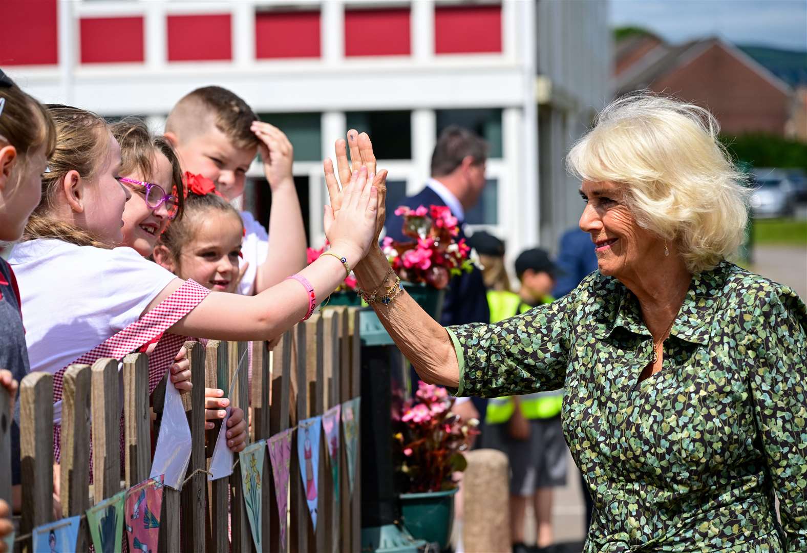 The Duchess of Cornwall high-fives pupils as she leaves Millbrook Primary School in Newport, South Wales (Finbarr Webster/PA)