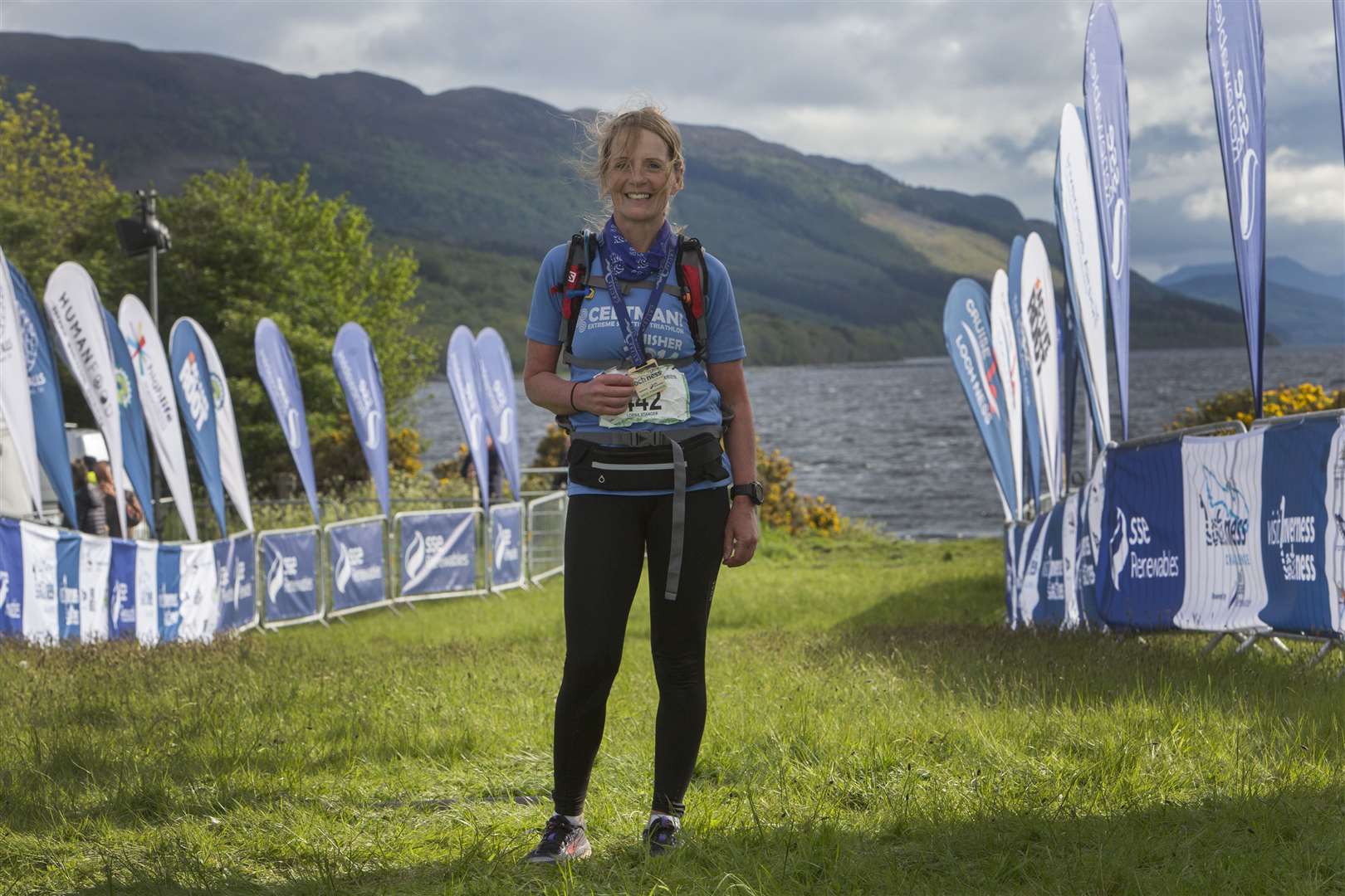 Lorna Stanger shows her third-place female medal at the finishing line of the Loch Ness Ultra Marathon Challenge. Picture: Robert MacDonald / Northern Studios