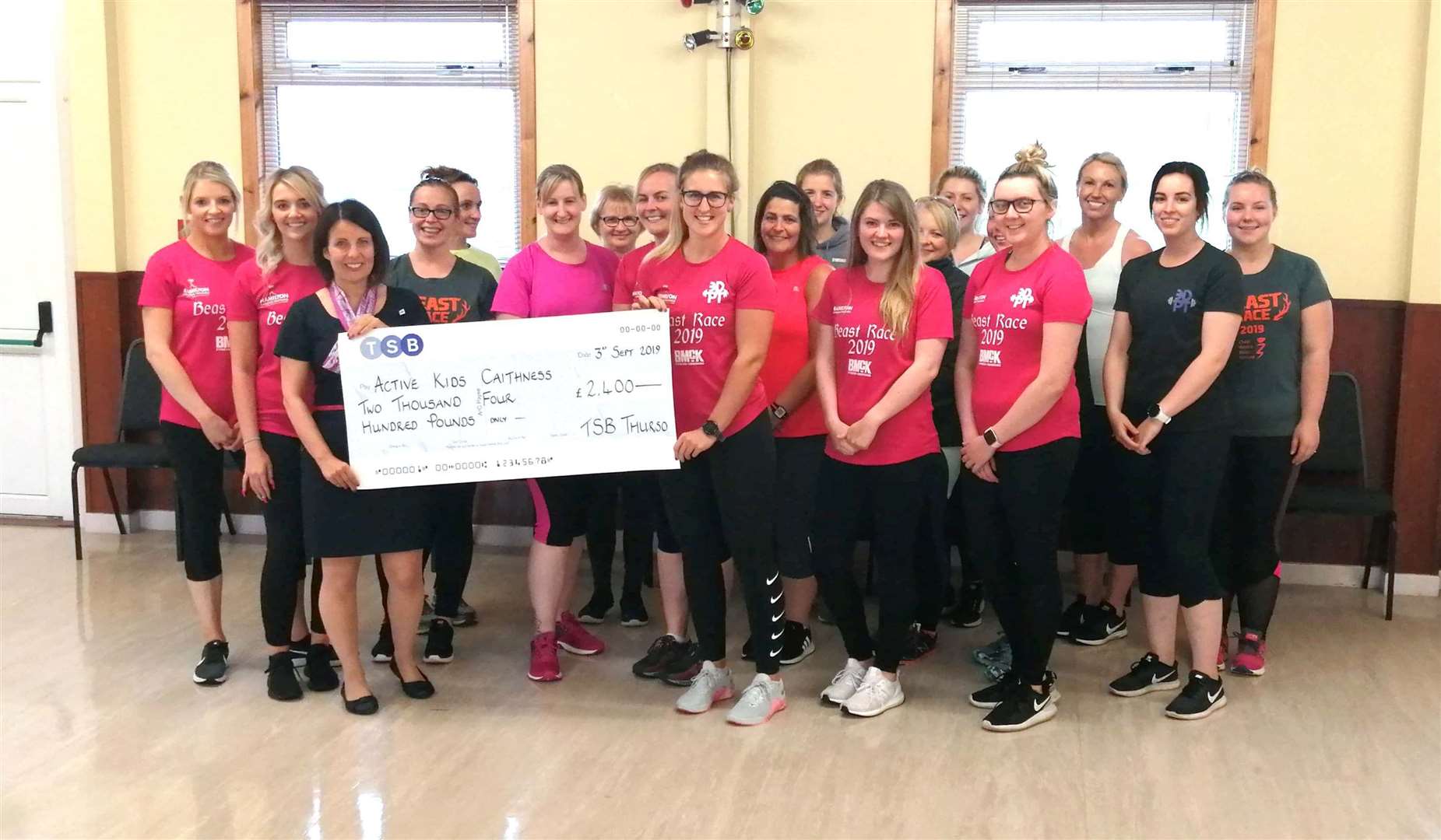 Anne Mackay, third from left, from Thurso TSB hands over a £2400 cheque to Sarah Dunnett from the Active Kids charity. Pictured with them are other charity members and TSB staff.