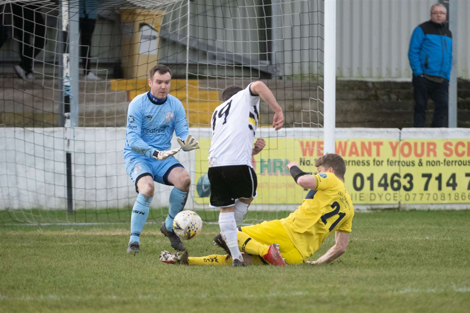 Wick keeper James More is ready to make a save as Ross Allan tackles Clachnacuddin's Kieran Chalmers. Picture: Callum Mackay