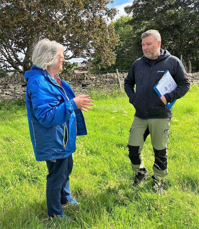 Jane Coll and David McGovern during an earlier visit to the site where the new stone will be erected.
