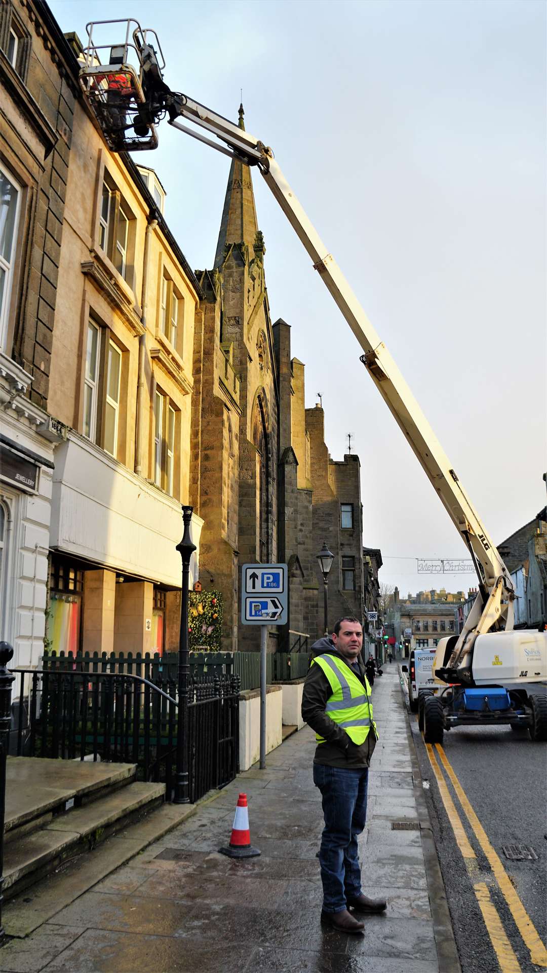 Jonathan Miller stands by as the cherry picker operator, Steven Sinclair, gets to work. Picture: DGS