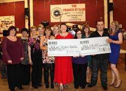 Suzie Taylor (fourth from right) presents the two cheques to accident and emergency nurse Alison Geddes (centre) and Steven Taylor (second from right), for Cancer Research UK.
