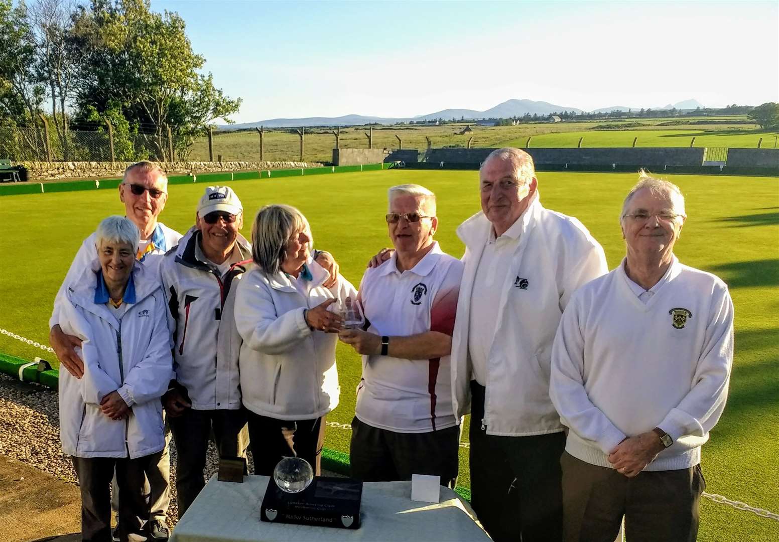 From left: Runners-up K De Jonckheere, A McKillop and P Hollingworth (Dornoch), F Manners, Lybster president, presenting family bowl to J Robertson, I Miller and P Knowles (St Fergus) with the Malky Sutherland Open Trophy on the table.