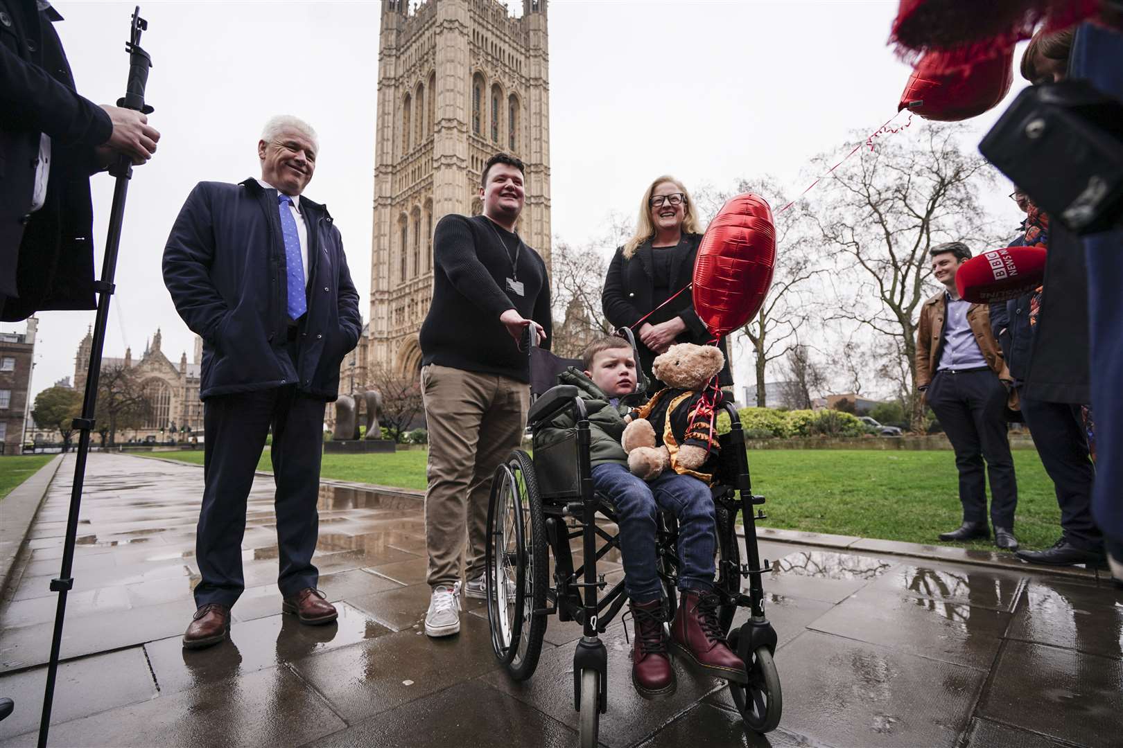 Daithi MacGabhann, six, and his father Mairtin, centre, outside the Houses of Parliament in London (Jordan Pettitt/PA)