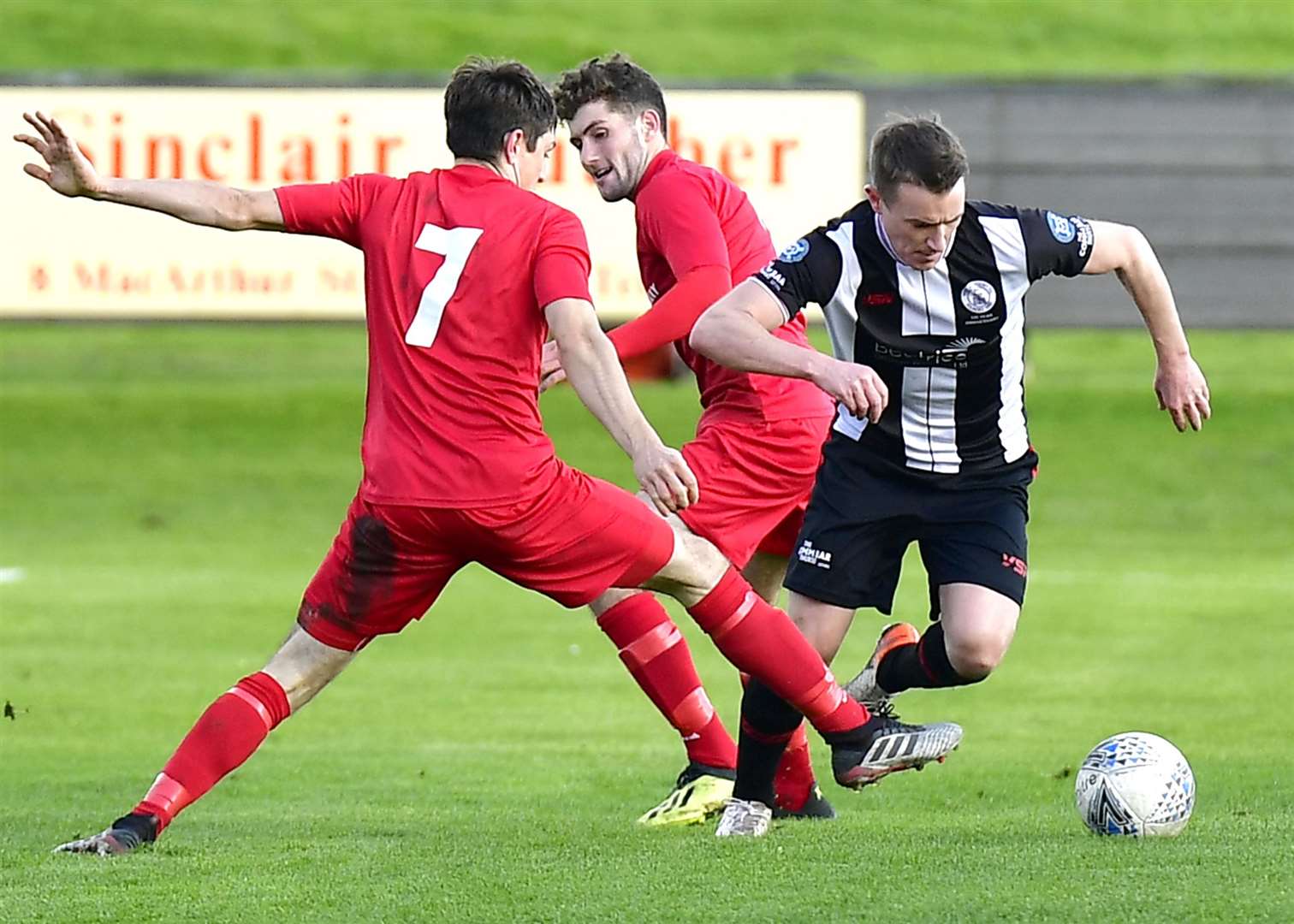 Wick Academy's Gary Manson goes past Brora's John Pickles during the derby at Harmsworth Park in October. Manson is now in a co-manager role. Picture: Mel Roger