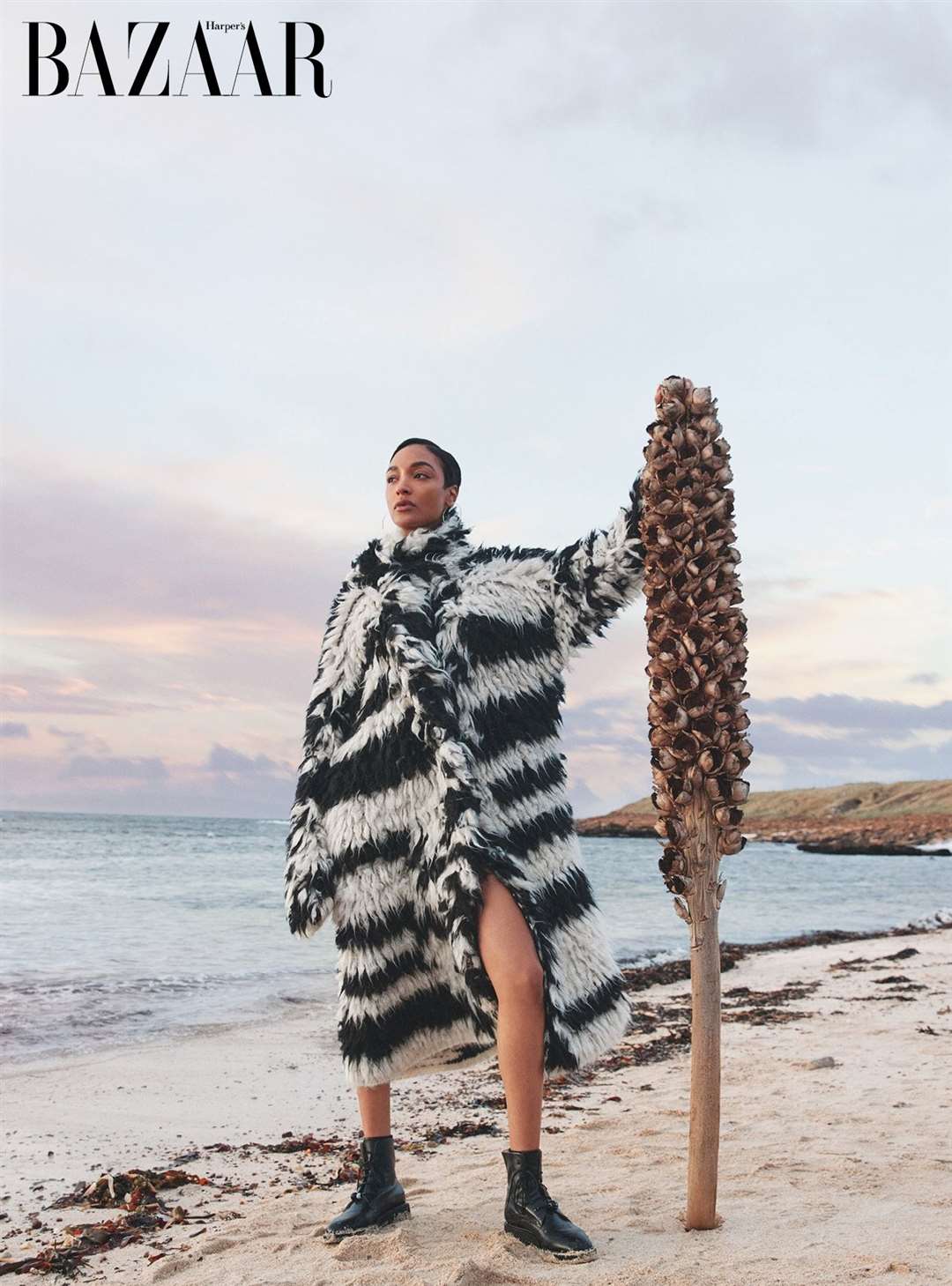 Jourdan Dunn strikes a dramatic pose on the coastline near the castle. Picture: Harper’s Bazaar UK/Richard Phibbs
