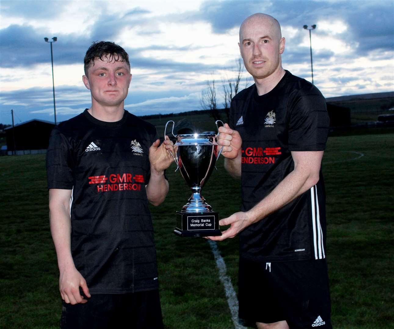 Lybster's Gary Weir (right) with man of the match Alfie Mackay holding the Craig Banks Memorial Cup. Picture: Alan Hendry