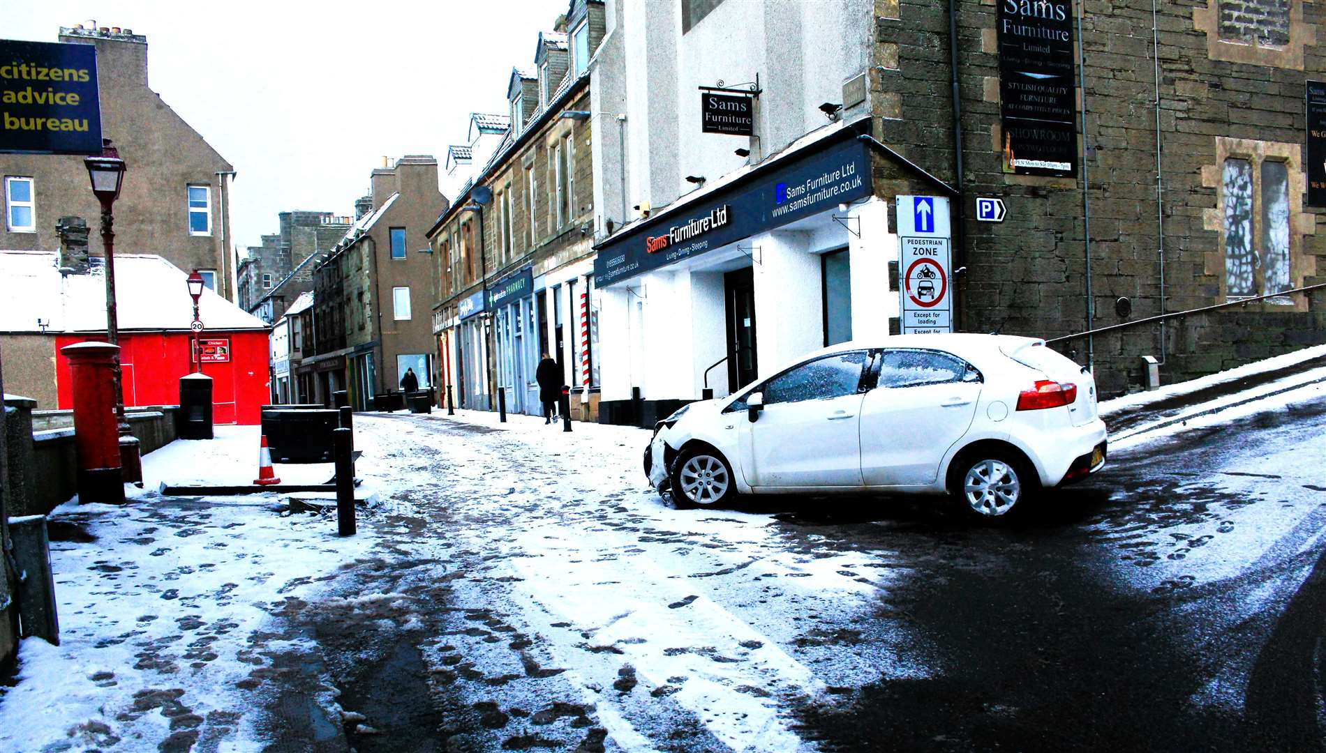 A car appeared to have slid in the snow at the bottom of Shore Lane in Wick, striking a large 'pedestrian zone' sign at the eastern end of High Street. Picture: AH