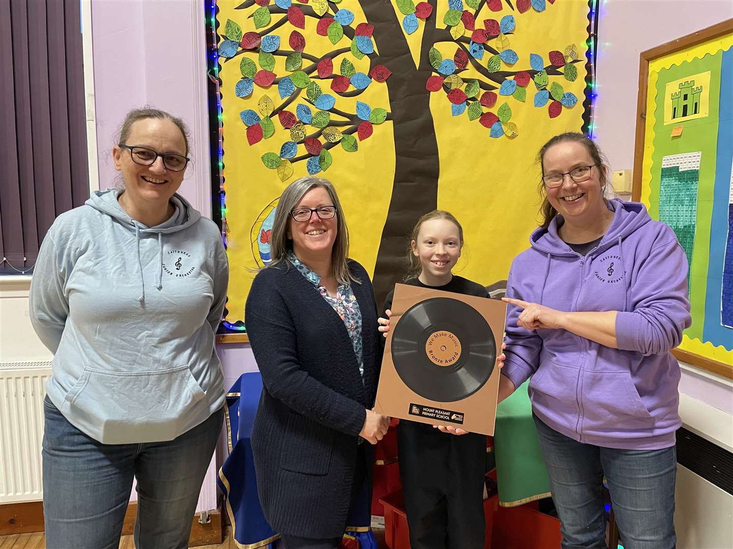 Susie Dingle (left) and Katrina Gordon of caithnessmusic.com presenting the bronze We Make Music schools award to Mount Pleasant head teacher Suzanne Urquhart and pupil Eva Cameron.