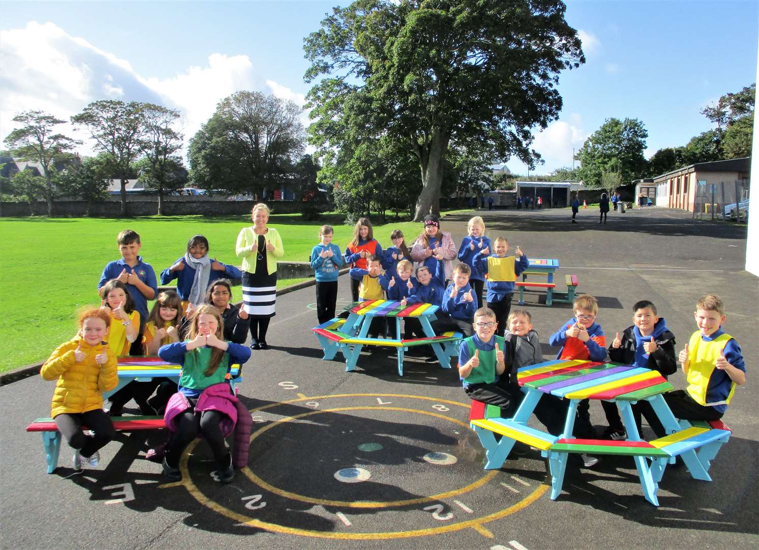 Receiving the benches is Miller Academy head teacher Jacqui Budge with pupils from P1, P2 and P3.