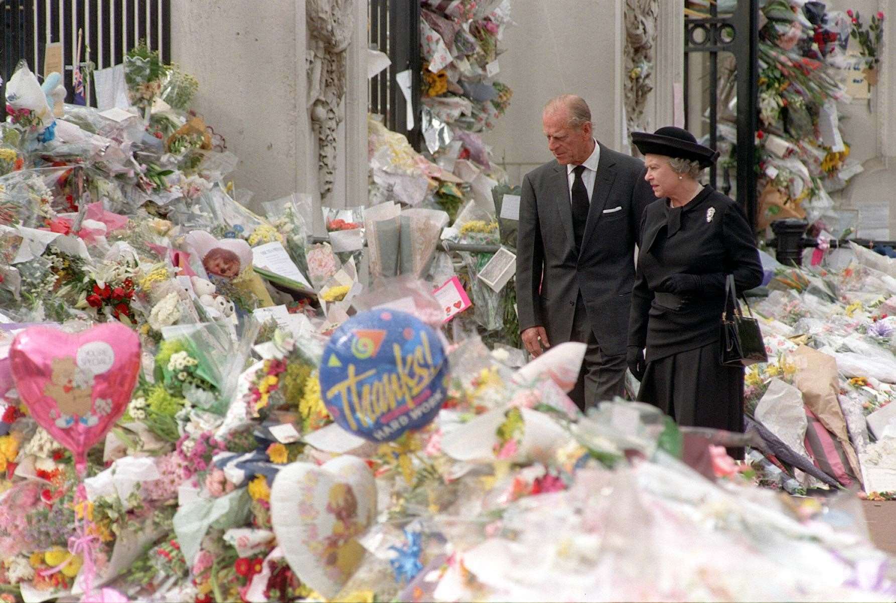 The Queen and the Duke of Edinburgh viewing the floral tributes to Diana, Princess of Wales, at Buckingham Palace (John Stillwell/PA)
