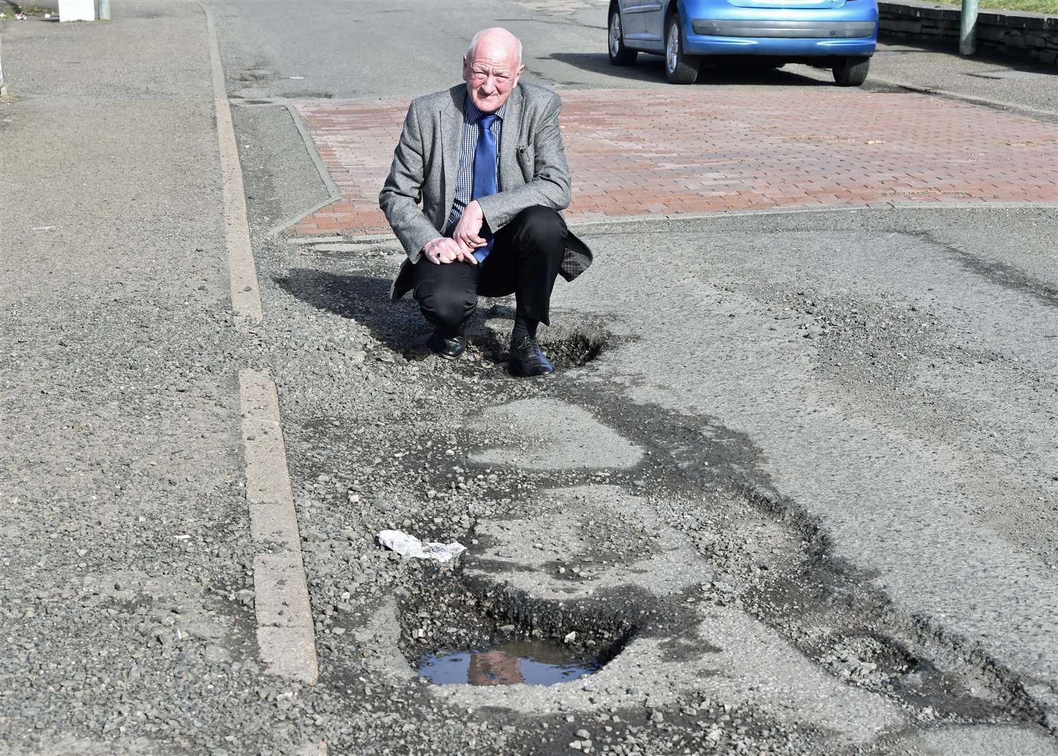 Iain Gregory of Caithness Roads Recovery highlighting potholes on Castle Terrace, Thurso. Picture: Mel Roger
