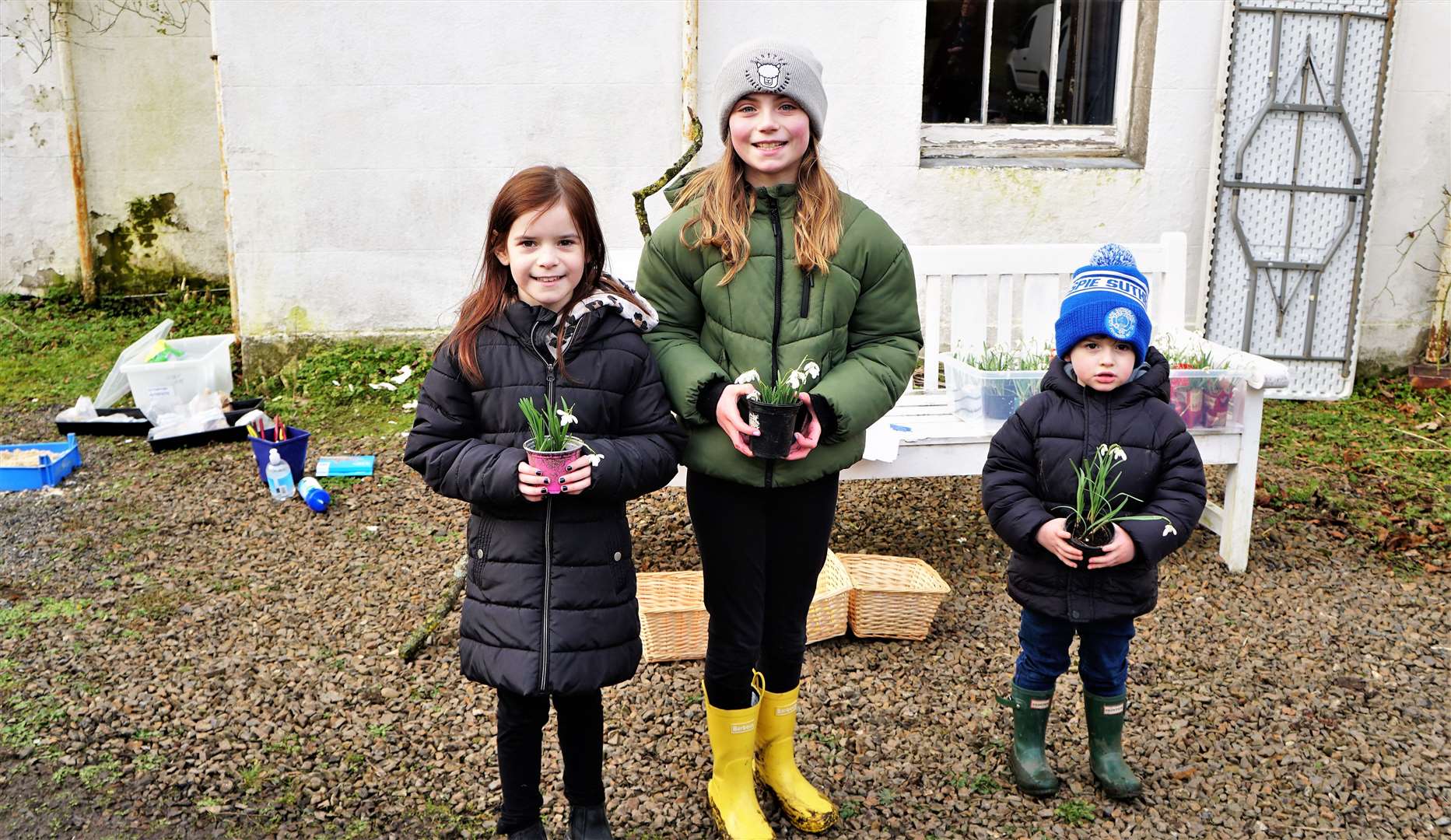 From left, Isla, Rhea and Harris got their own snowdrops to take home and plant. Picture: DGS