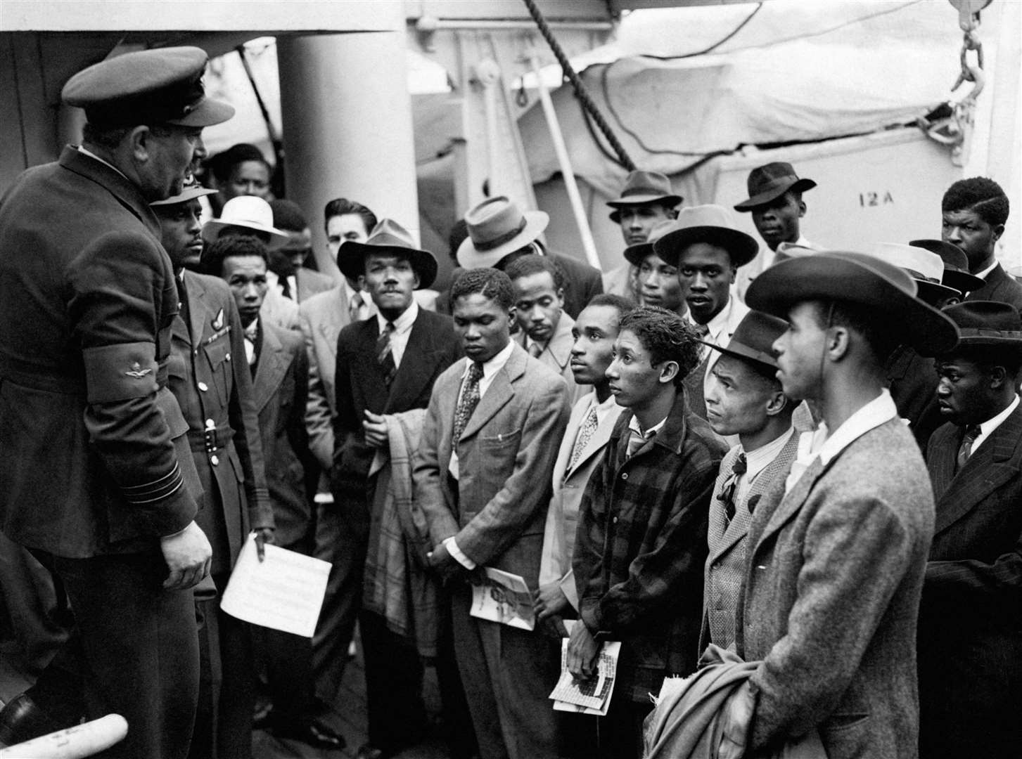 Jamaican immigrants welcomed by RAF officials from the Colonial Office after the ex-troopship HMT ‘Empire Windrush’ landed them at Tilbury (PA)
