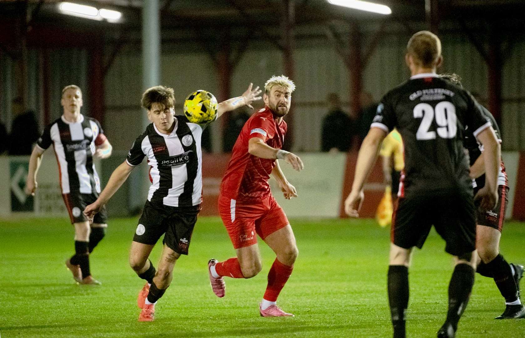Gary Pullen of Wick Academy holds off Brora's Jordan MacRae. Picture: Callum Mackay