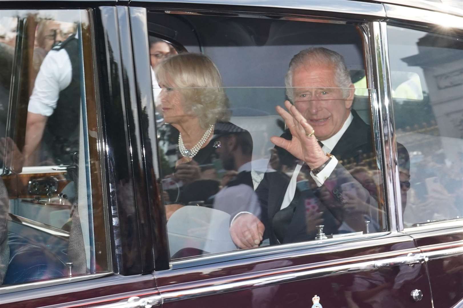 The King and Queen waved from the state Rolls Royce to well-wishers who lined the roads as they left Buckingham Palace (James Manning/PA)