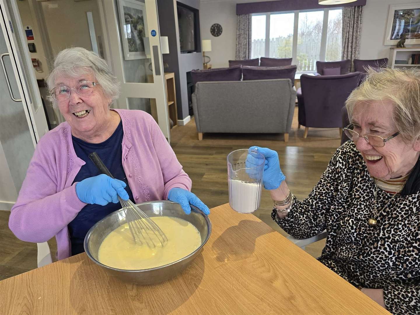 Rena Warren and Wilma Stewart mix the cake to make it lovely and light.