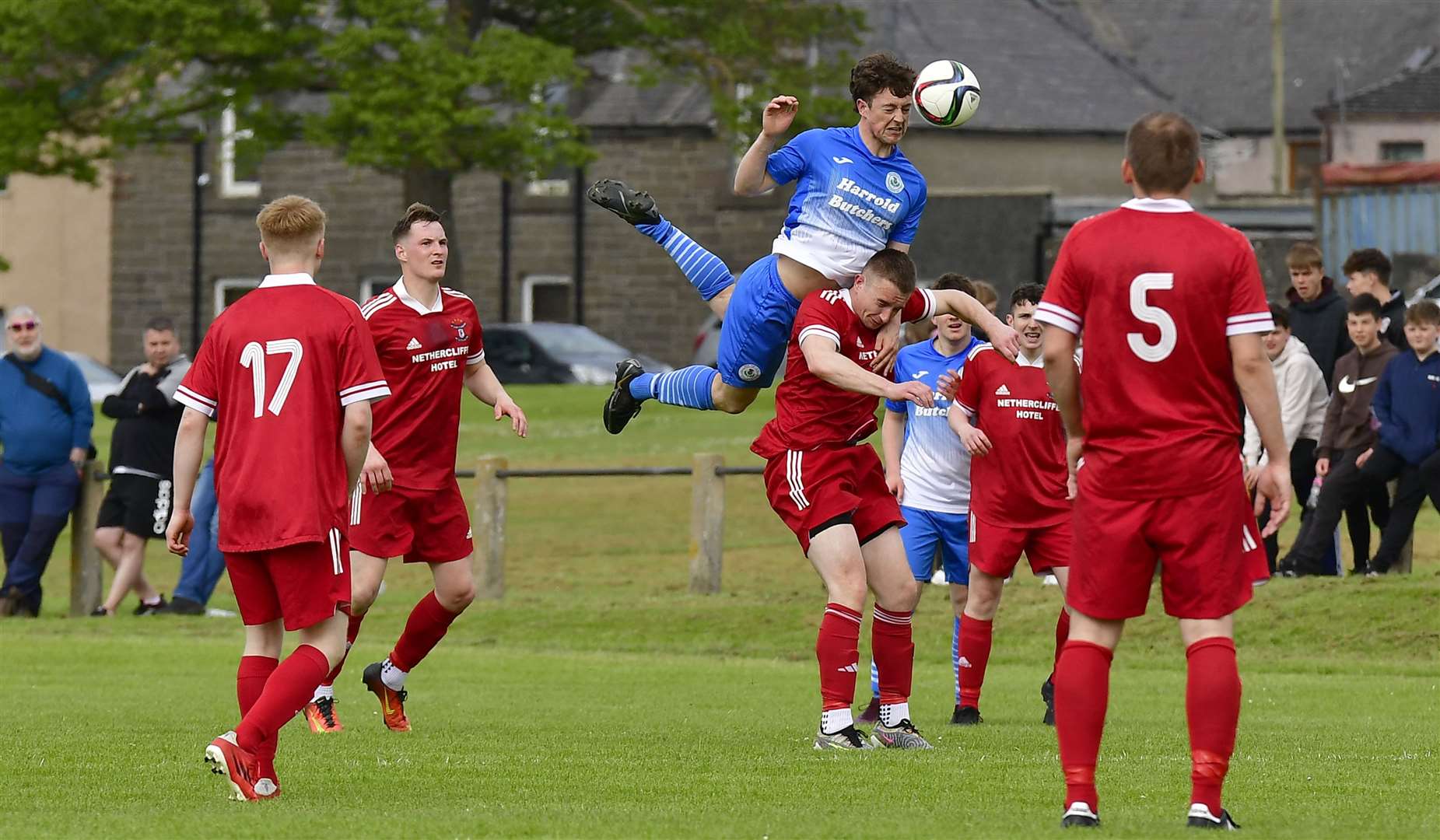 Wick Thistle's Steven Sutherland flies over the top of Wick Groats opponent Taylor Campbell. Picture: Mel Roger