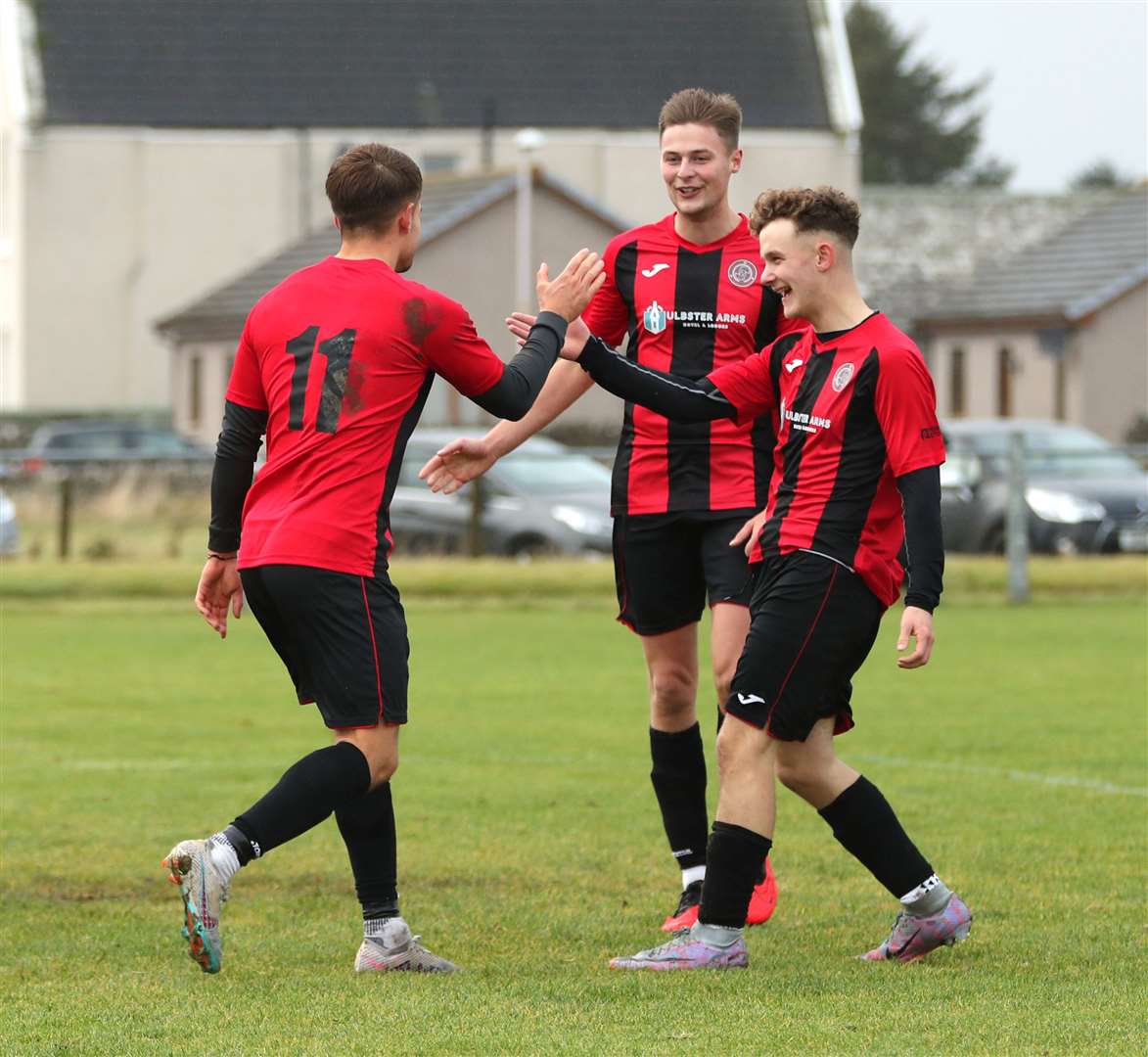 Mark Munro and James Mackintosh congratulate goalscorer Jonah Martens during Halkirk United's recent 6-1 victory over Orkney at Morrison Park. Picture: James Gunn