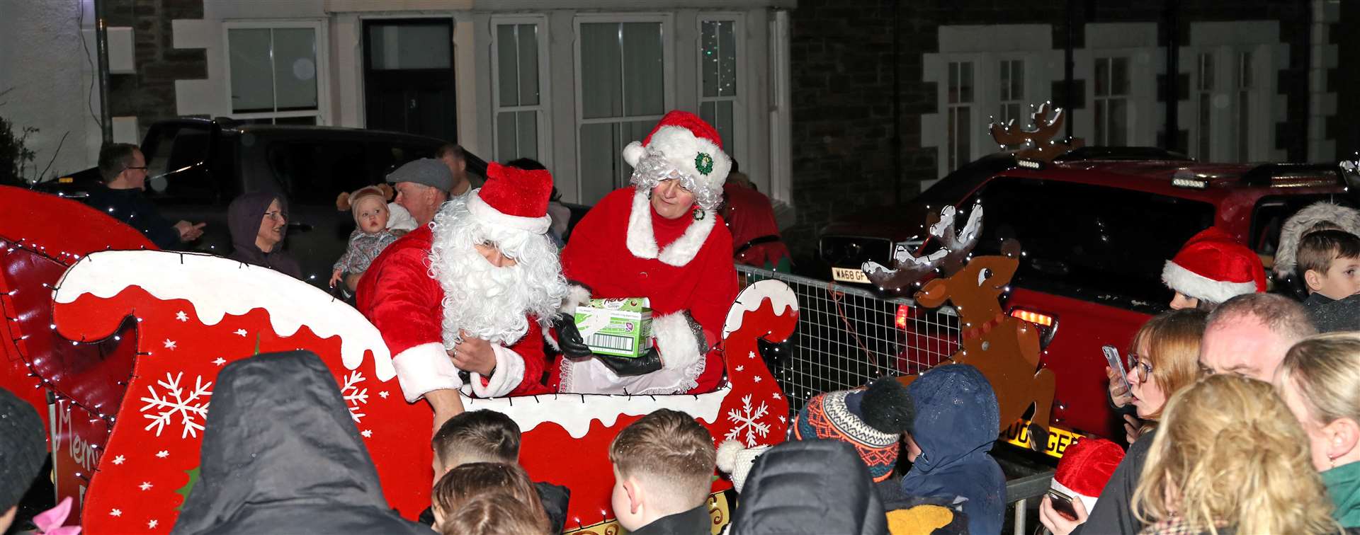Santa and Mrs Claus hand out sweets from the sleigh pulled by reindeer with the help from a small truck. Picture: James Gunn