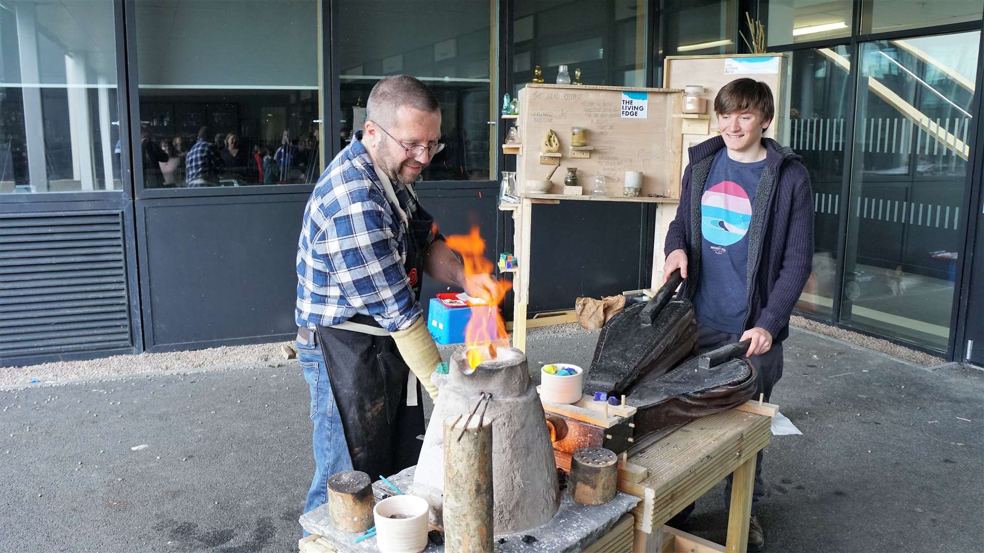 Glass artist Michael Bullen had a special furnace and was trying to recreate the patterned glass bead recovered in an archaeological dig at Swartigill this year. His son Will is helping operate the bellows for the furnace. Picture: DGS