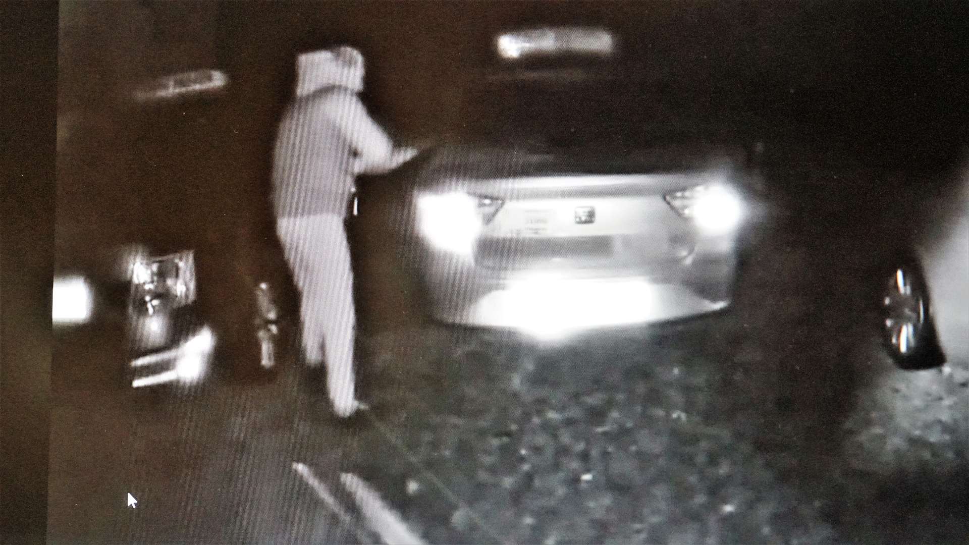 A still taken from the CCTV footage showing the man apparently smearing glue on the cars.