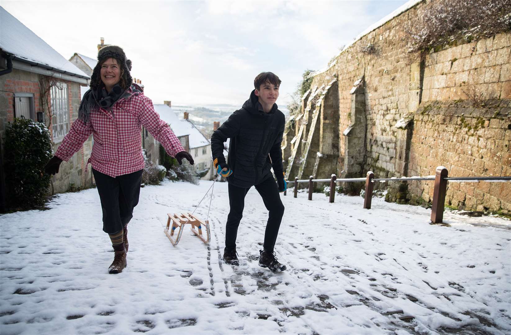 People sledging on Gold Hill, in Shaftesbury, Dorset (Andrew Matthews/PA)