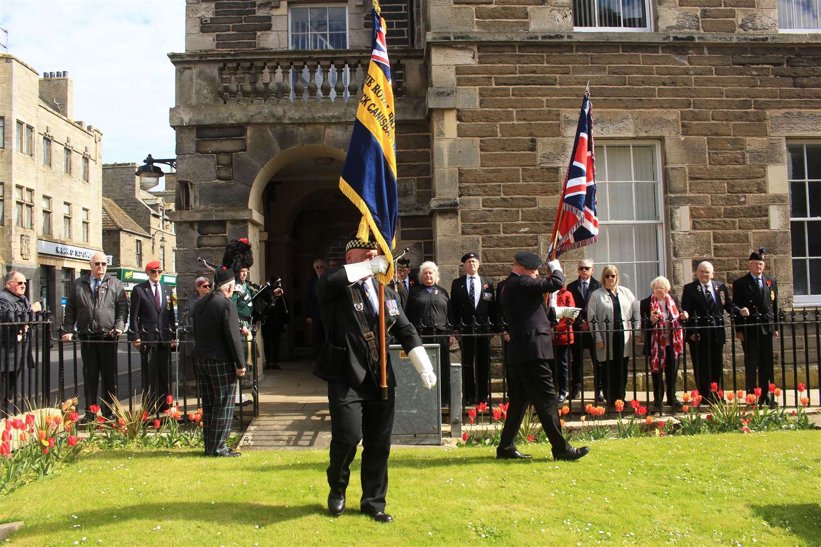 Standard-bearers Kevin Stewart and Kevin McDonald making their way into the garden of remembrance at Wick Town Hall. Picture: Alan Hendry
