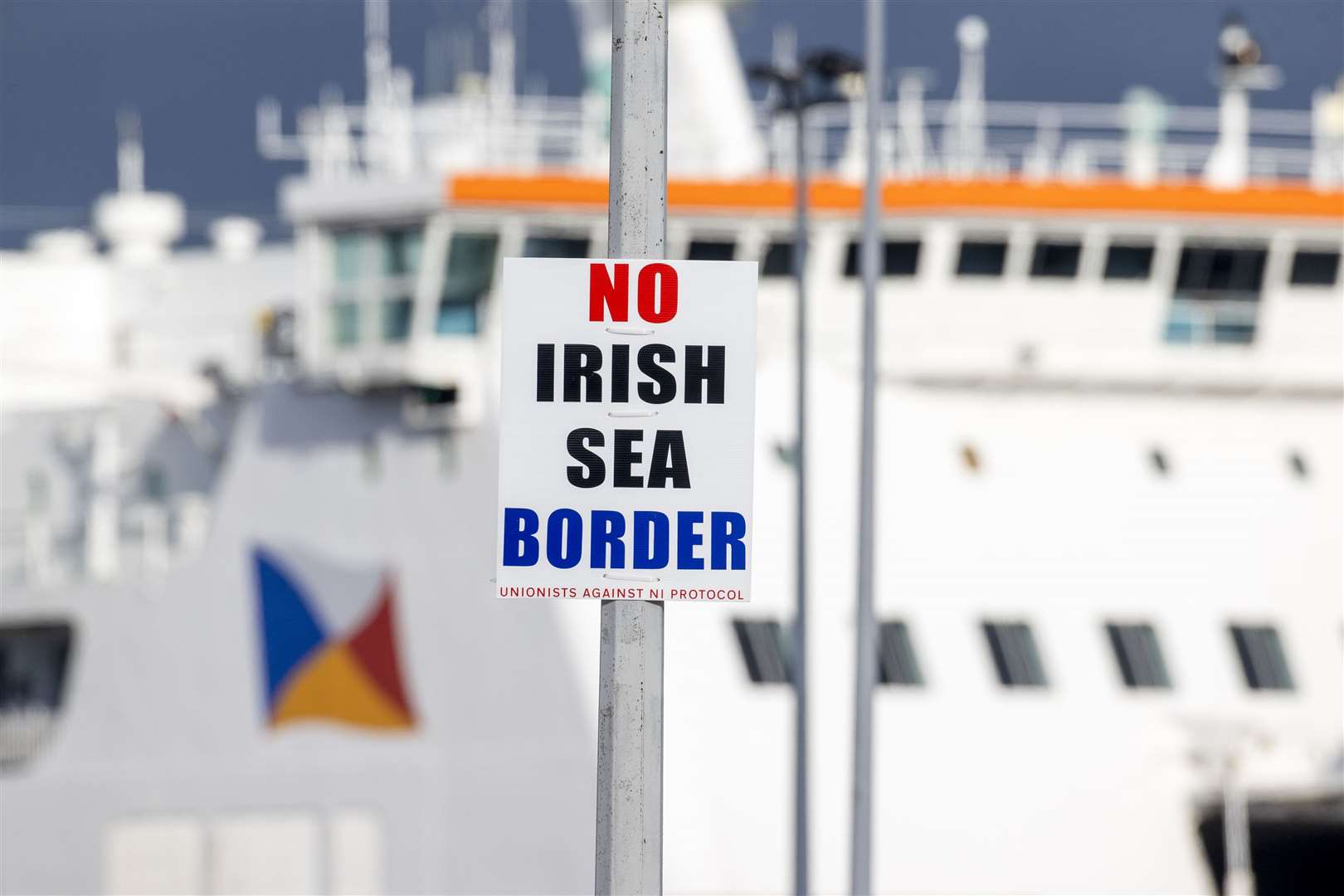 A sign on a lamppost outside Larne Port with the word ‘No Irish Sea Border’ (Liam McBurney/PA)