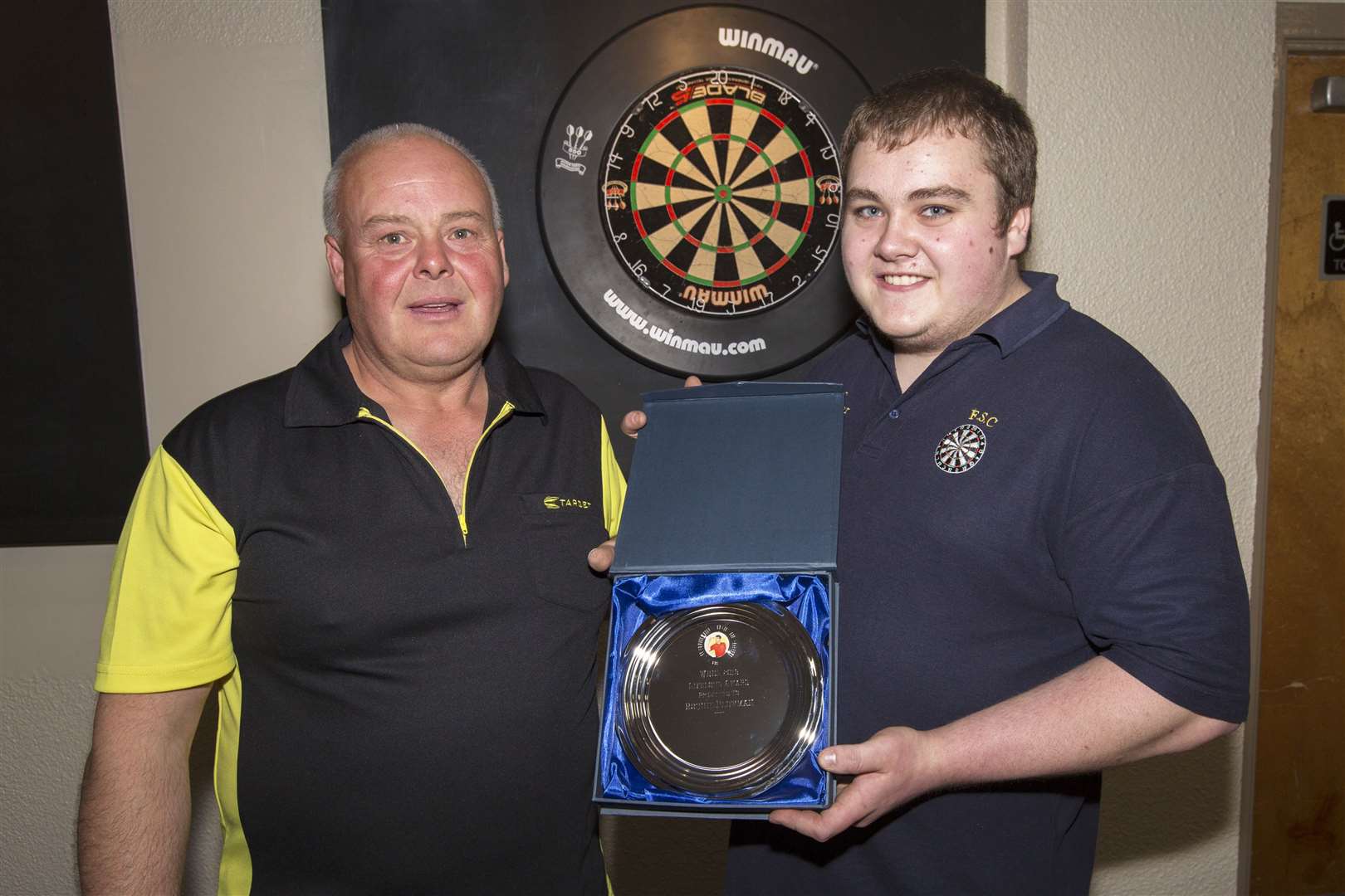 Before the start of Wick and District Darts League's new season, Ronnie Plowman (left) was presented with a lifetime award for his dedication to the sport. The presentation was made by Martin Nicolson. Ronnie has been playing darts for 40 years, having begun as part of the Nethercliffe team. He now plays for Seaforth Club. Cath Begg, of Keiss, received a similar award, but she was not present to receive her trophy. Picture: Robert MacDonald / Northern Studios