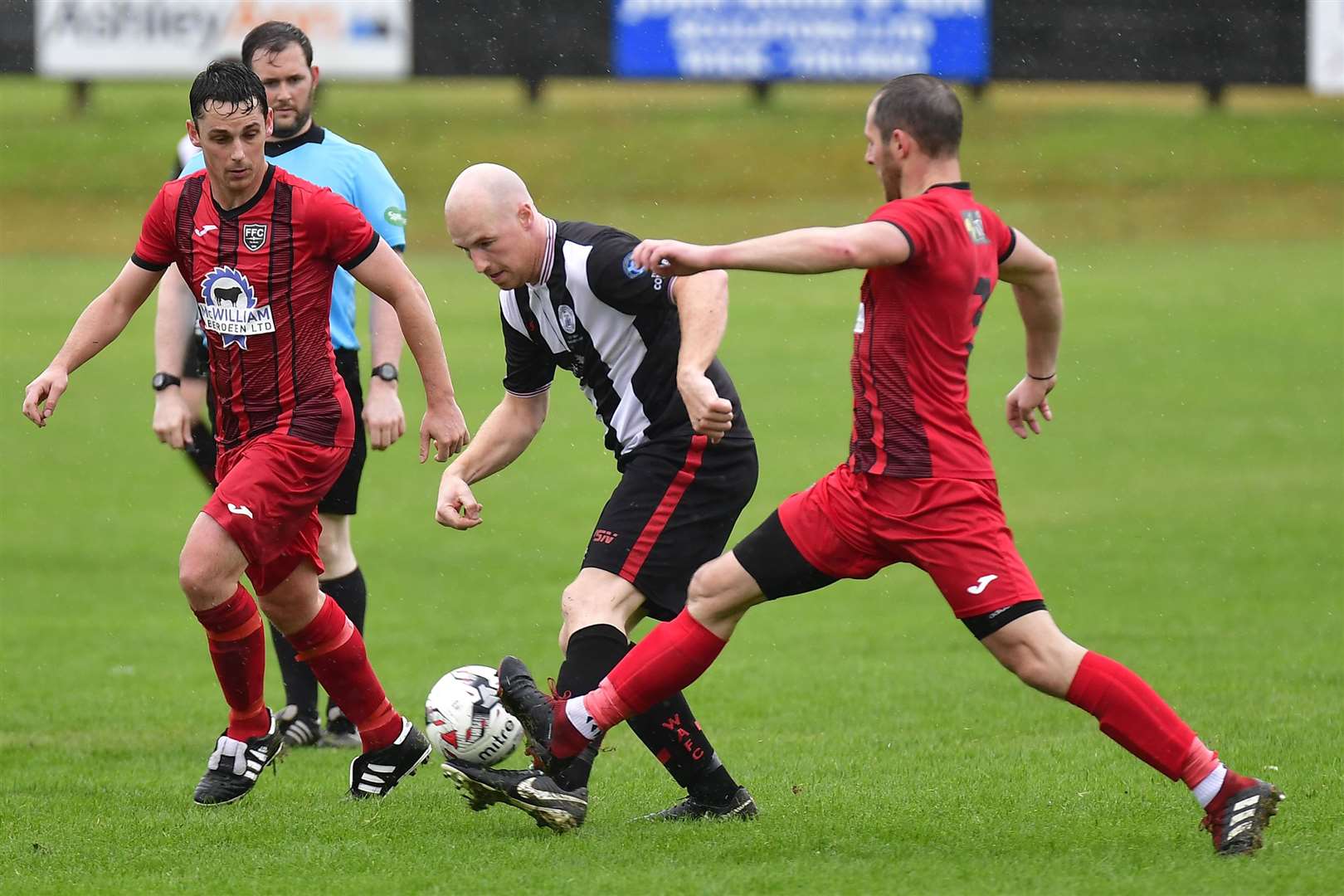 Wick substitute Gary Weir rolling back the years as he goes past Fraserburgh's Grant Campbell and Bryan Hay. Picture: Mel Roger