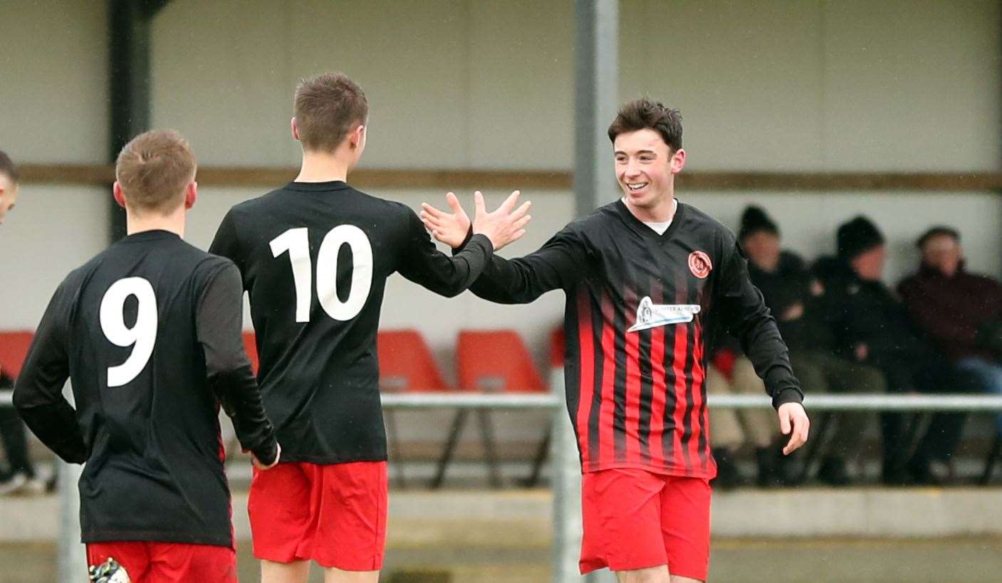 No. 10 James Mackintosh congratulates Kyle Henderson after he scored Halkirk's second against Inverness Athletic. Picture: James Gunn