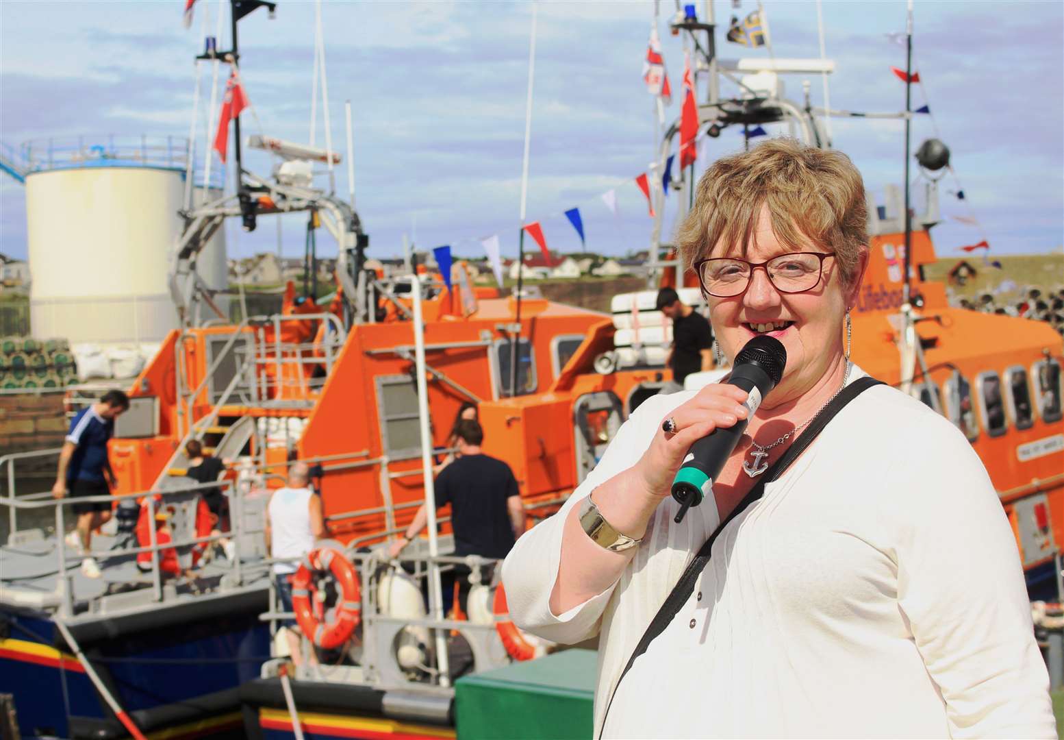 Harbour Day compere Jenny Szyfelbain in front of the Longhope and Wick lifeboats. Picture: Alan Hendry
