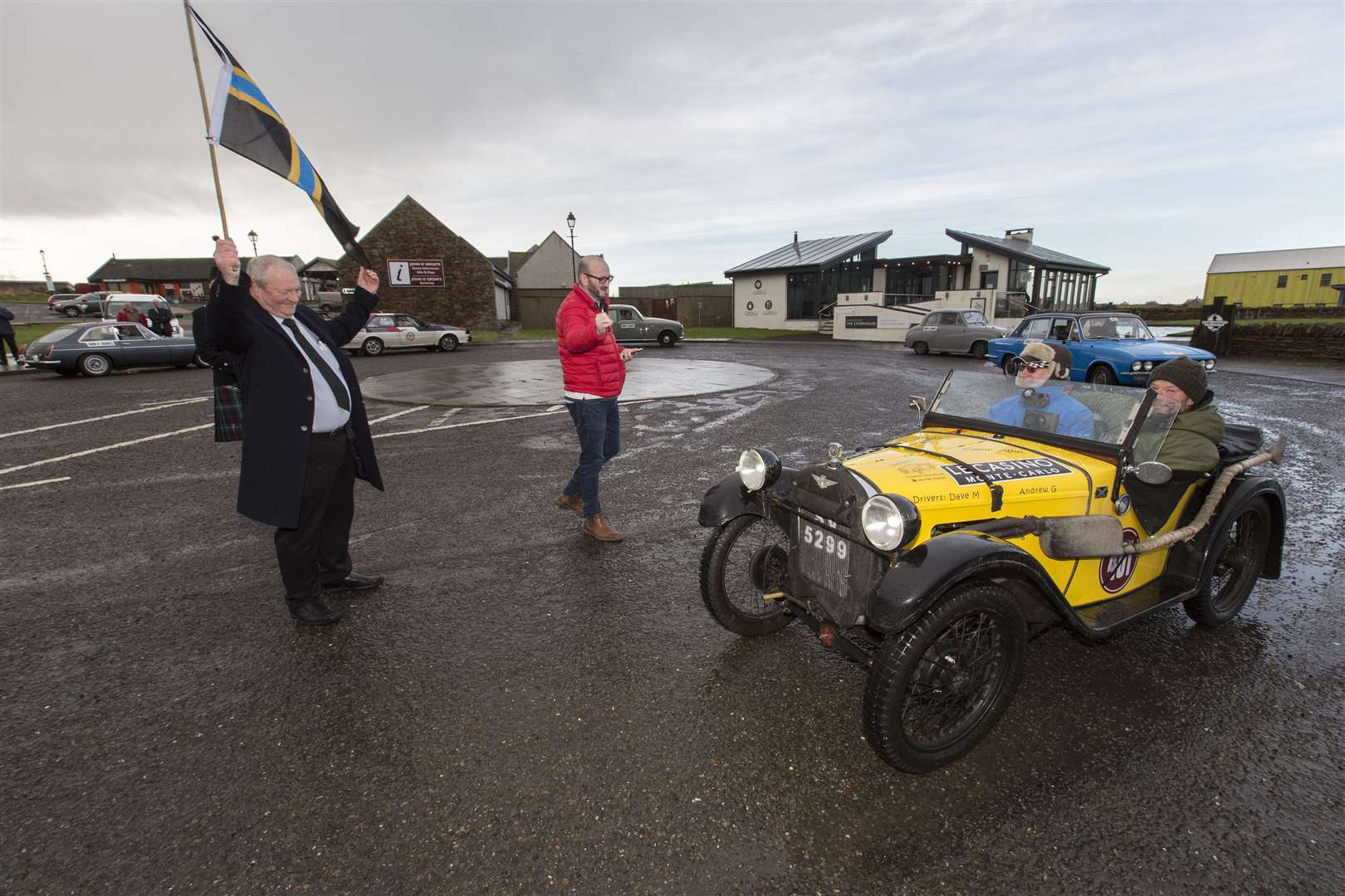 Andrew Goodlellow and Dave Muir from Dundee in their 1930 Austin 7 Elite are flagged off from John O'Groats by Walter Mowat. Picture: Robert MacDonald / Northern Studios