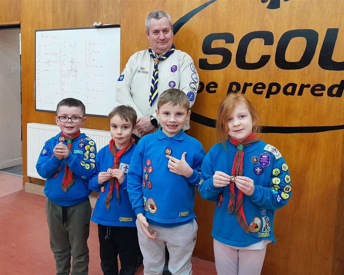 District Commissioner Gary Stronach with (from left) Owen Harding, Rhys McBeath, Sammie Hall and Sophie Miller.
