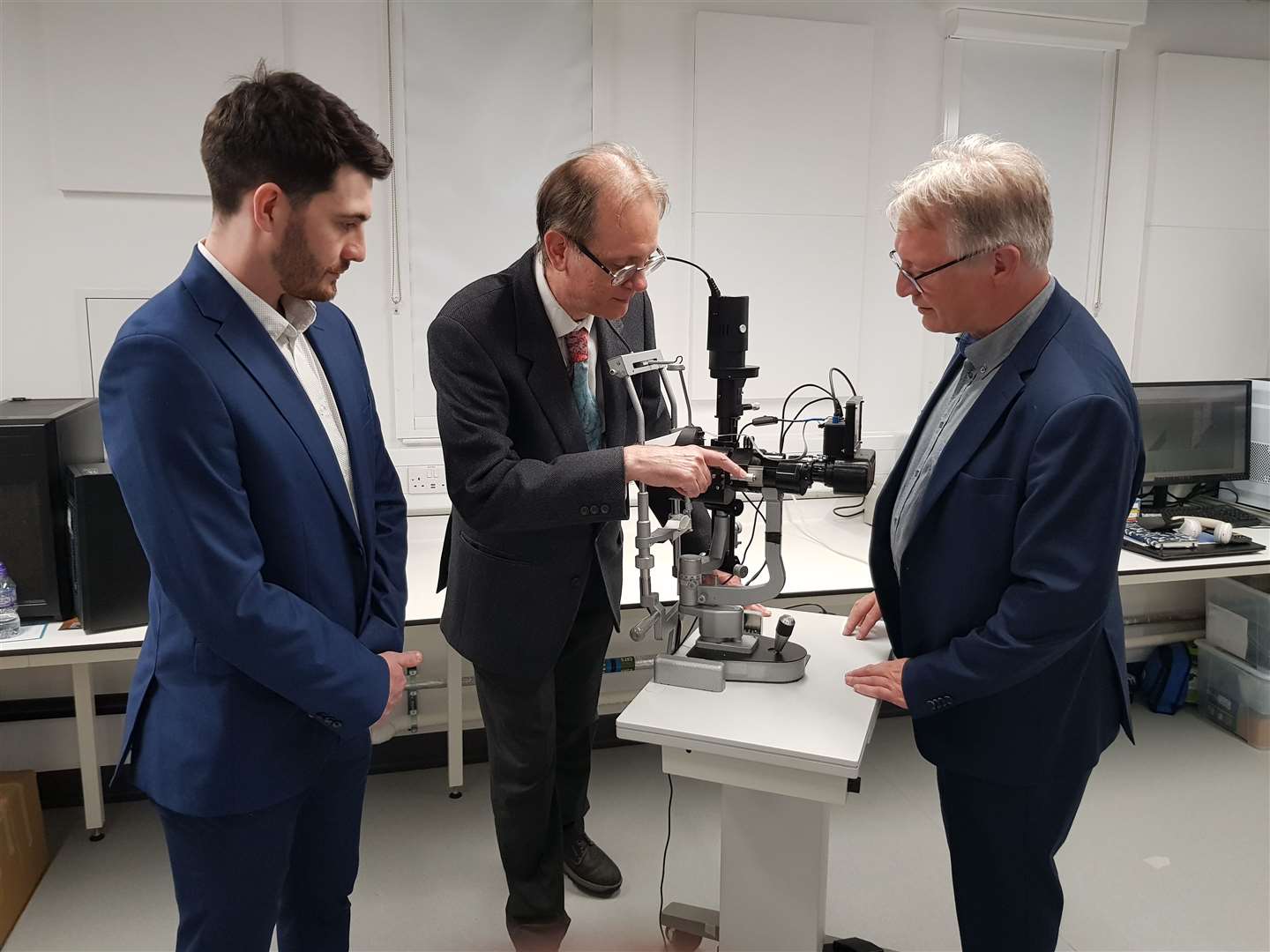 Dr Mario Giardini demonstrates the device with Jamie Thomson and Jan Boers from medical devices company IDCP (University of Strathclyde/PA)