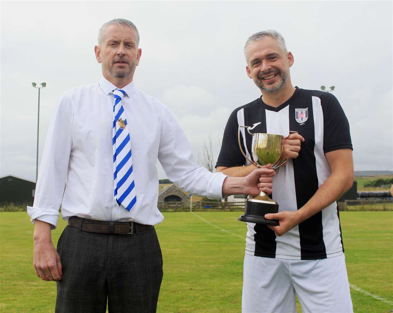 Lybster chairman Andrew Mackenzie presenting the Steven Cup to Darryn Mackay of Swifts. Picture: Alan Hendry