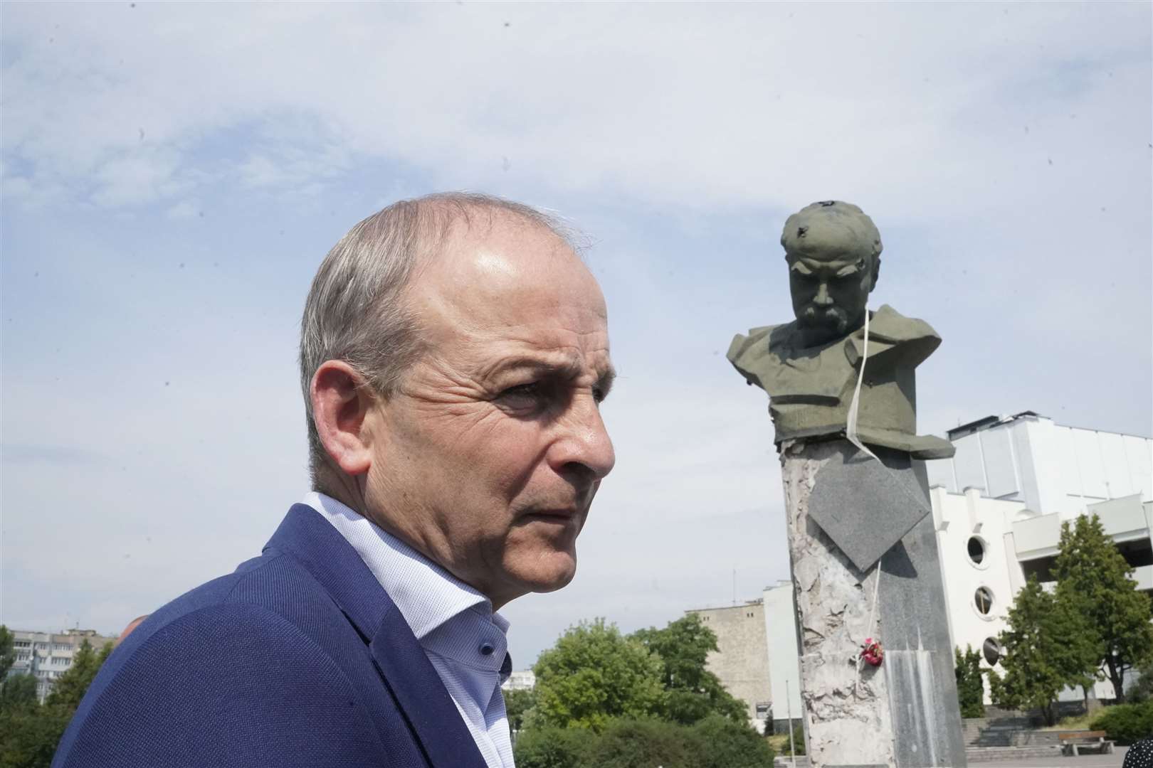 Taoiseach Micheal Martin viewing the damage to the statue of poet Taras Shevchenko in Borodyanka (Niall Carson/PA)