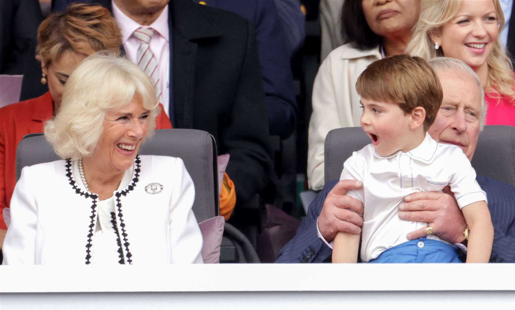 Camilla laughs with Prince Louis, who is held by Charles, during the Platinum Jubilee Pageant (Chris Jackson/PA)