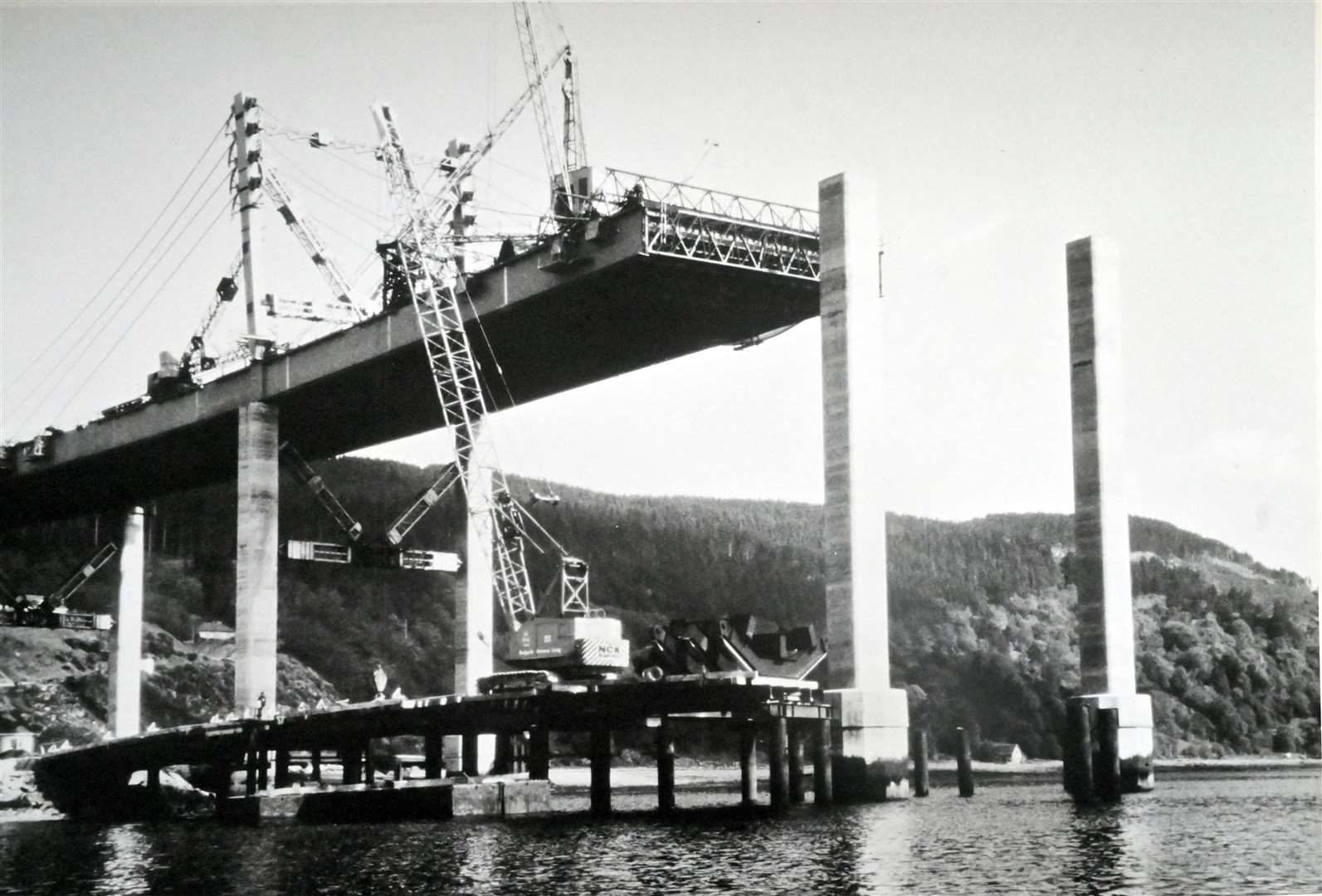 A dramatic image of the bridge under construction.