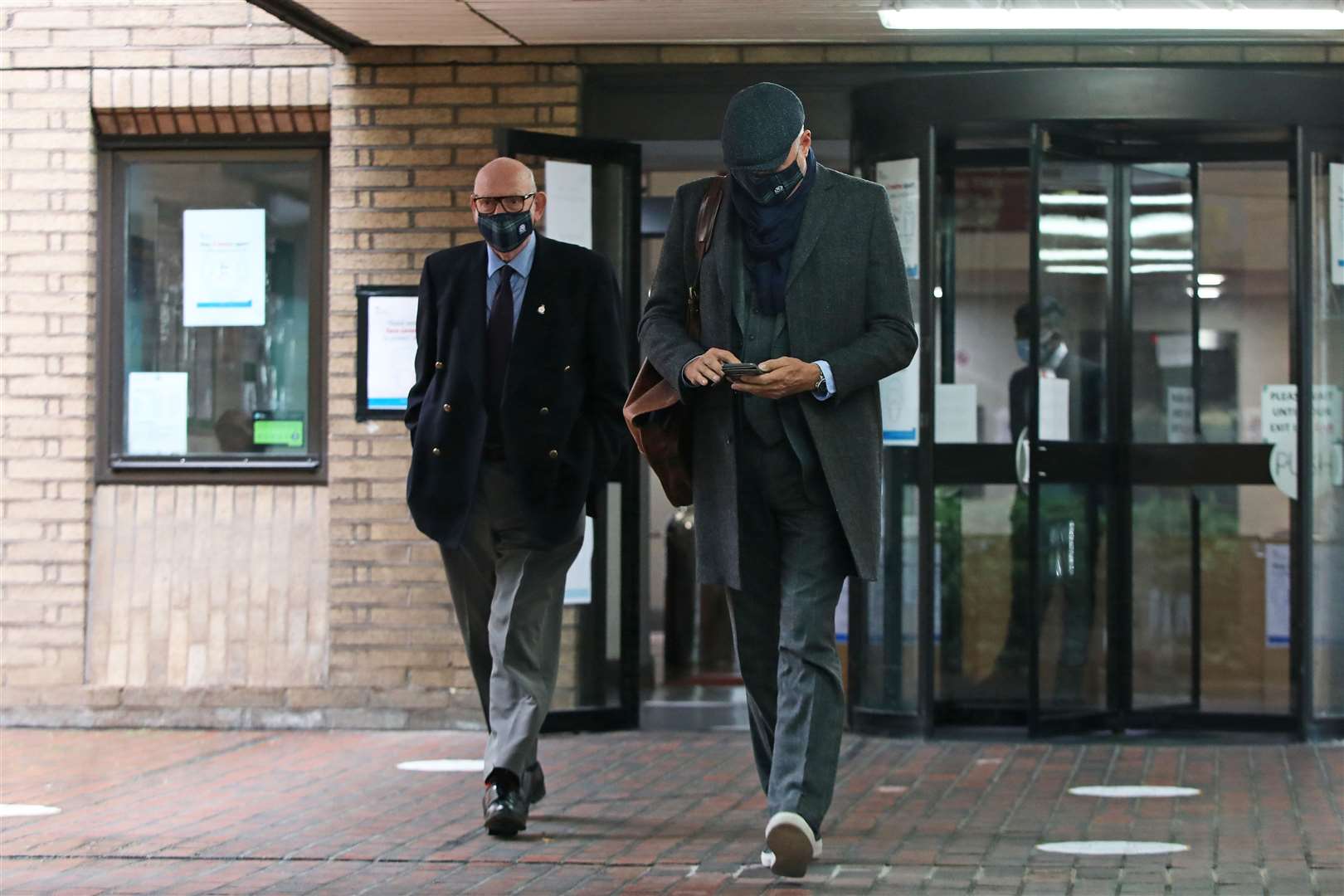 John Leslie, with his father Lesley Stott (left), leaves Southwark Crown Court (Luciana Guerra/PA)