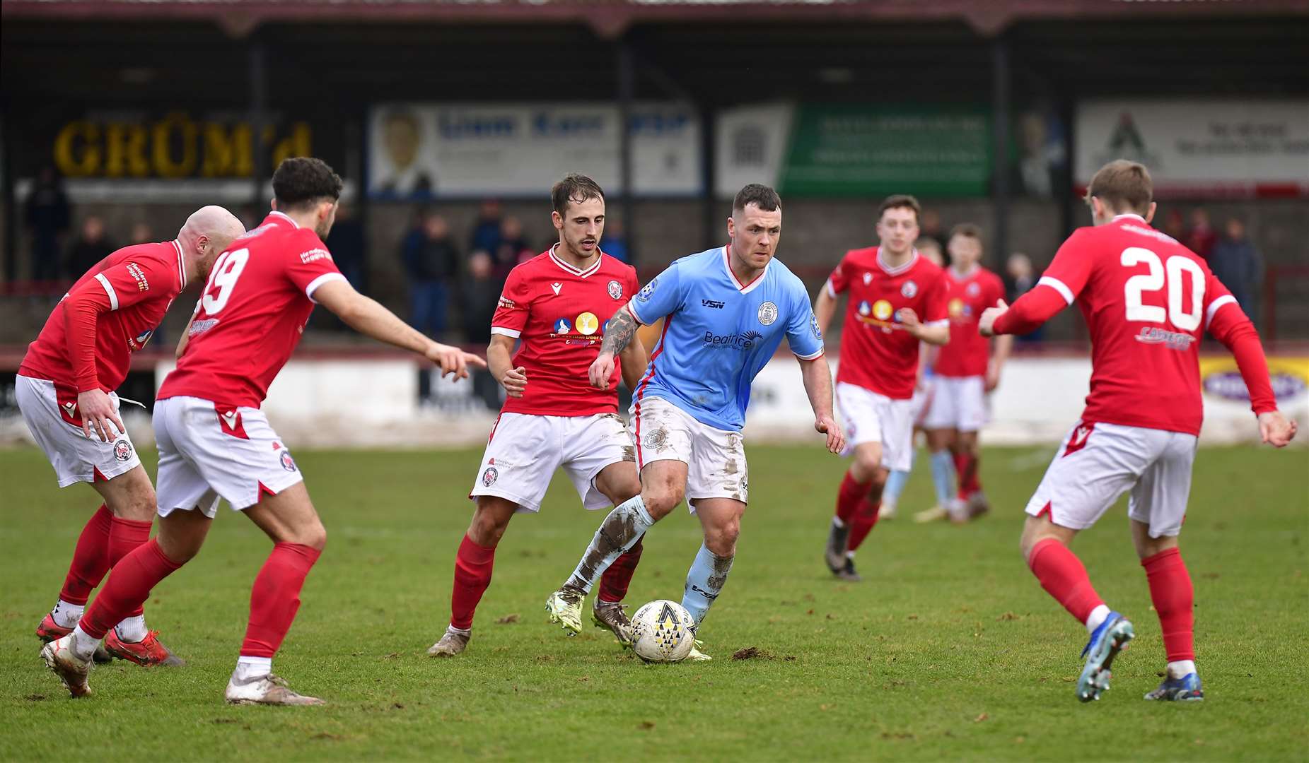 If you want it, come and get it: Gordon MacNab finds himself surrounded by Brechin City players. Picture: Mel Roger