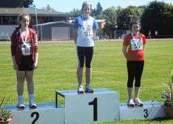 Stephanie Eyers on the centre of the podium following her victory in the under-14 girls javelin with her longest ever throw of 22.88m.