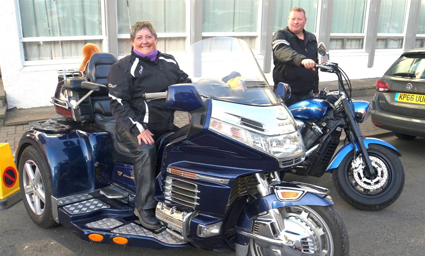 Linda Gallon's enormous Honda trike dwarfs her son on his Yamaha.